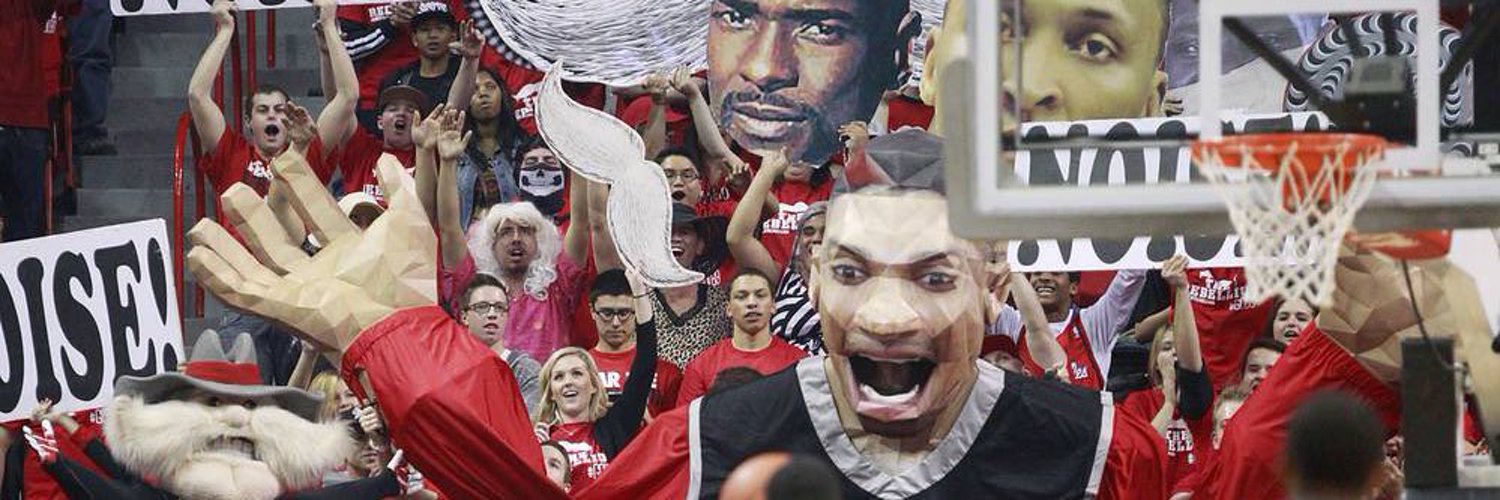 A packed student section with Hey Reb! signs