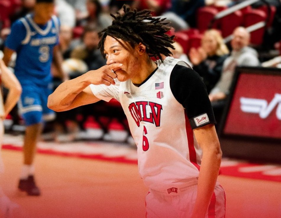 A UNLV basketball player making the Hey Reb! mustache with his hand